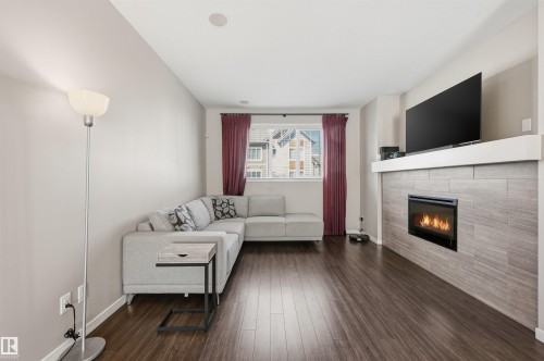 4 320 Secord Boulevard, Edmonton, AB - Indoor Photo Showing Living Room With Fireplace