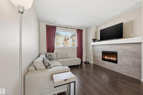 4 320 Secord Boulevard, Edmonton, AB - Indoor Photo Showing Living Room With Fireplace