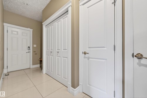 Entryway featuring light-toned tile flooring, white baseboards, and neutral wall paint - 1254 Adamson Drive, Edmonton, AB - Indoor Photo Showing Other Room