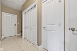 Entryway featuring light-toned tile flooring, white baseboards, and neutral wall paint - 
