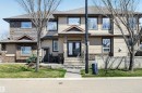 Multi-level residence featuring a stone and siding exterior, prominent front entry with double doors, and a concrete walkway - 1254 Adamson Drive, Edmonton, AB  - Outdoor With Facade 