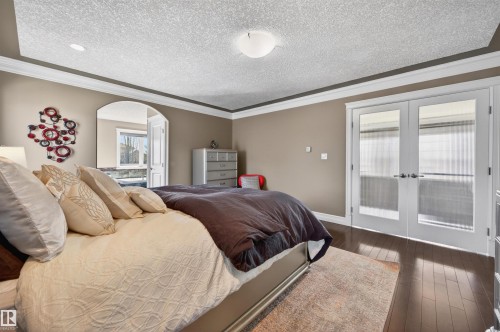 Hardwood-style flooring and crown molding - 1254 Adamson Drive, Edmonton, AB - Indoor Photo Showing Bedroom