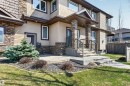 Inviting front entrance featuring stacked stone pillars, concrete steps with wrought iron railings, and a covered porch - 1254 Adamson Drive, Edmonton, AB  - Outdoor 