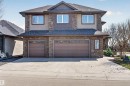 Two-story residence featuring a stone and siding exterior with a dark shingle roof - 1254 Adamson Drive, Edmonton, AB  - Outdoor With Facade 
