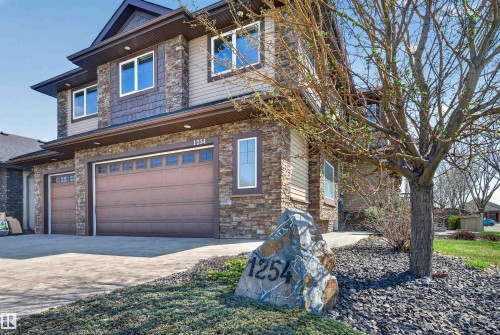 Stone and siding exterior with a multi-car garage - 1254 Adamson Drive, Edmonton, AB - Outdoor
