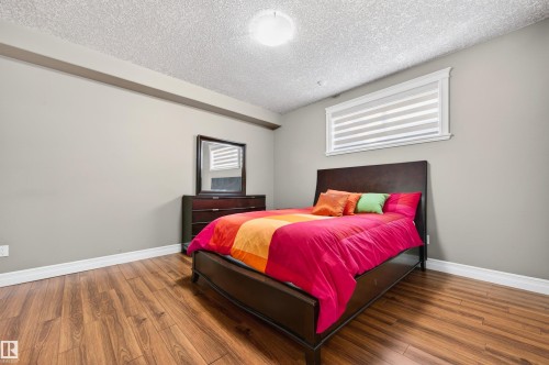 Bedroom featuring wood-finish flooring, neutral wall tones, and white baseboards - 1254 Adamson Drive, Edmonton, AB - Indoor Photo Showing Bedroom