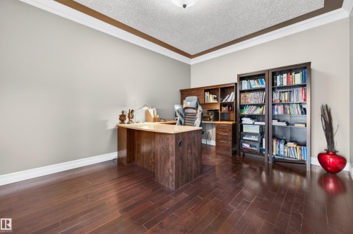 Rich wood-finish flooring complements light-toned walls and crisp white baseboards - 1254 Adamson Drive, Edmonton, AB - Indoor Photo Showing Office