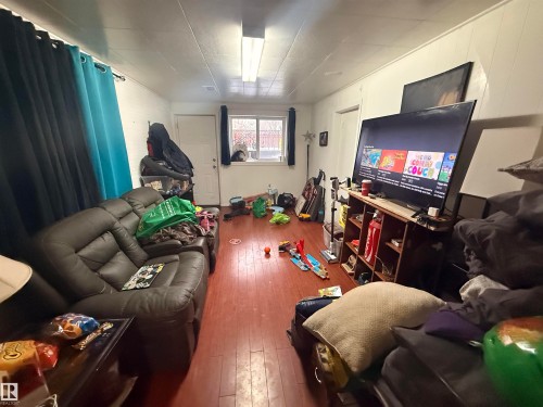 This room features wood flooring, white walls, and a window with a view of the outside - 10545 67 Avenue, Edmonton, AB - Indoor