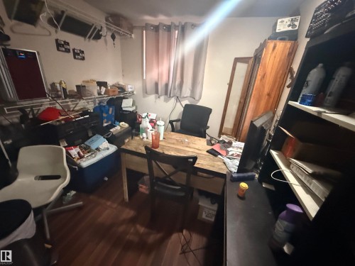 The room features hardwood style flooring, a window with curtains, and a wooden desk - 10545 67 Avenue, Edmonton, AB - Indoor Photo Showing Office