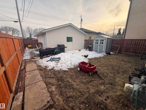 The property features a fenced yard with a detached garage and a storage shed - 10545 67 Avenue, Edmonton, AB - Outdoor