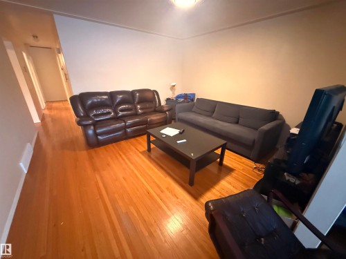 The living area features hardwood floors and neutral-toned walls - 10545 67 Avenue, Edmonton, AB - Indoor Photo Showing Living Room
