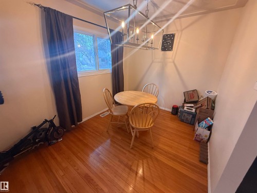 The room features hardwood floors and a window with natural light - 10545 67 Avenue, Edmonton, AB - Indoor