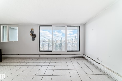 Expansive windows frame a distant cityscape - 405 10135 Saskatchewan Drive Nw, Edmonton, AB - Indoor Photo Showing Other Room