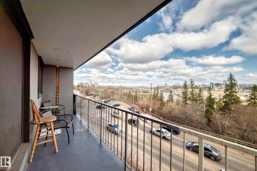 Private balcony featuring a painted concrete floor, metal railing, and a city skyline backdrop - 405 10135 Saskatchewan Drive Nw, Edmonton, AB - Outdoor With View