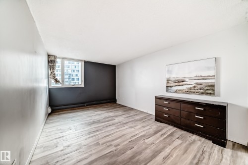 Light wood-finish flooring complements the neutral wall tones - 405 10135 Saskatchewan Drive Nw, Edmonton, AB - Indoor Photo Showing Other Room