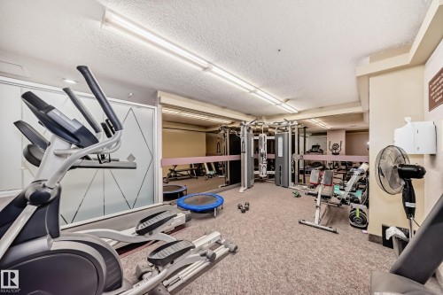 Dedicated fitness area featuring carpeted flooring and fluorescent lighting - 405 10135 Saskatchewan Drive Nw, Edmonton, AB - Indoor Photo Showing Other Room