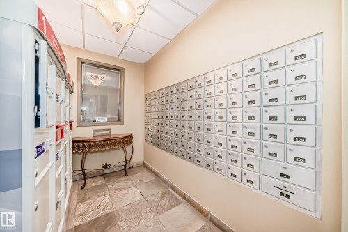 Dedicated mailroom featuring individual mailboxes and package delivery access - 405 10135 Saskatchewan Drive Nw, Edmonton, AB - Indoor