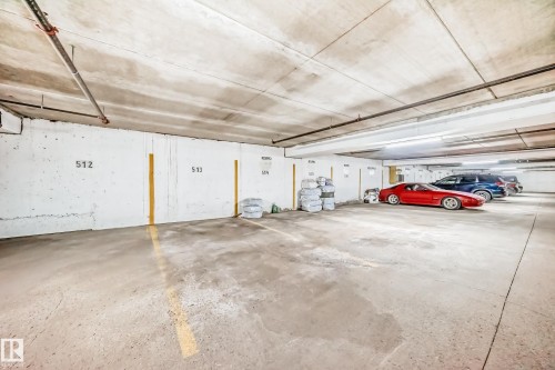 Underground parking garage featuring concrete flooring, structural columns, and overhead strip lighting - 405 10135 Saskatchewan Drive Nw, Edmonton, AB - Indoor Photo Showing Garage