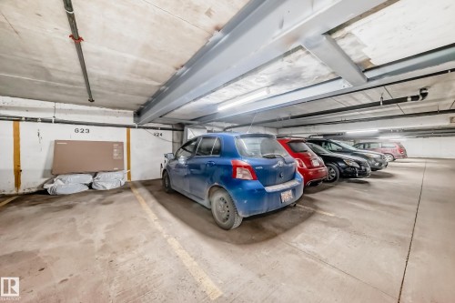 Underground parking space featuring concrete flooring and marked parking lines - 405 10135 Saskatchewan Drive Nw, Edmonton, AB - Indoor Photo Showing Garage