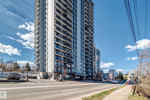 High-rise building with multiple private balconies, ground-level commercial spaces, and visible street access - 601 10135 Saskatchewan Drive Nw, Edmonton, AB - Outdoor With Facade