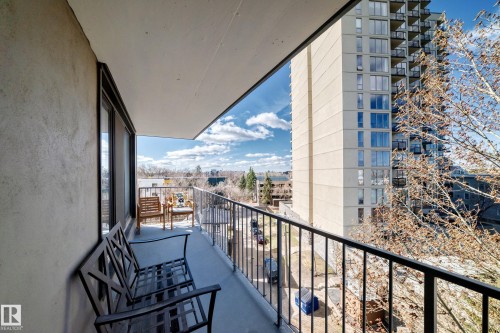 Balcony featuring a black metal railing, concrete flooring, and an expansive cityscape backdrop - 601 10135 Saskatchewan Drive Nw, Edmonton, AB - Outdoor With Exterior