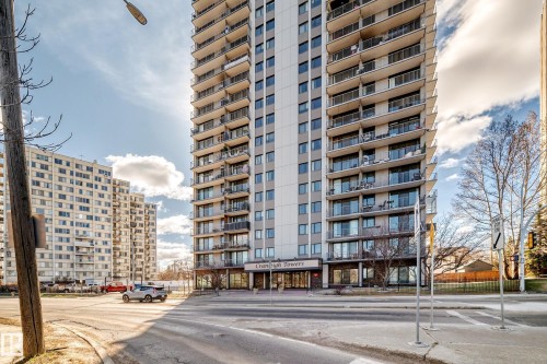 Multi-story building featuring multiple private balconies, a ground-level entrance with prominent signage, and a paved street frontage - 601 10135 Saskatchewan Drive Nw, Edmonton, AB - Outdoor With Facade