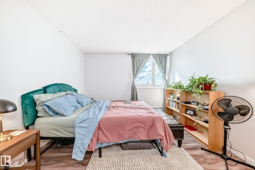 Room featuring wood-finish flooring, a window with drapery, and a white ceiling - 601 10135 Saskatchewan Drive Nw, Edmonton, AB - Indoor Photo Showing Bedroom