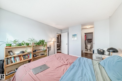 Spacious room featuring light-colored walls and wood-finish flooring - 601 10135 Saskatchewan Drive Nw, Edmonton, AB - Indoor Photo Showing Bedroom