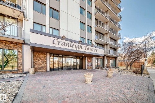"Cranleigh Towers" building entrance featuring a stone facade, a covered entryway, and a brick paver forecourt - 601 10135 Saskatchewan Drive Nw, Edmonton, AB - Outdoor