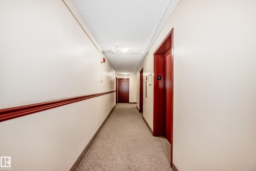 Hallway with neutral walls, textured carpet, and a drop ceiling - 601 10135 Saskatchewan Drive Nw, Edmonton, AB - Indoor Photo Showing Other Room