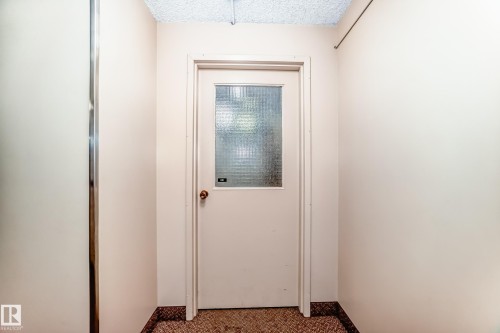 Entryway featuring a white door with a privacy glass insert, complemented by a gold-toned doorknob - 601 10135 Saskatchewan Drive Nw, Edmonton, AB - Indoor Photo Showing Other Room