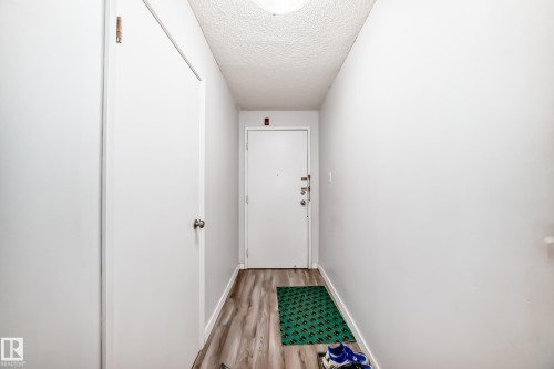 Entryway featuring wood-finish flooring, white walls, and a textured ceiling - 601 10135 Saskatchewan Drive Nw, Edmonton, AB - Indoor Photo Showing Other Room
