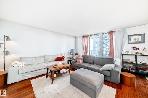 Living area featuring wood-finish flooring and a white color palette - 601 10135 Saskatchewan Drive Nw, Edmonton, AB - Indoor Photo Showing Living Room