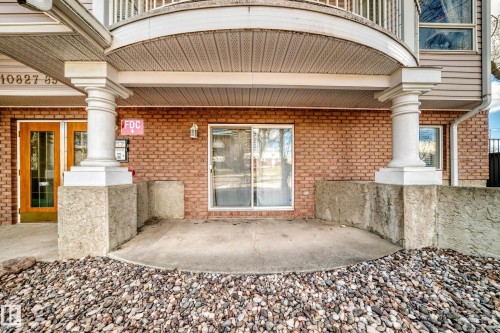 Covered outdoor patio area featuring a brick exterior facade - 101 10827 85 Avenue Nw, Edmonton, AB - Outdoor With Exterior