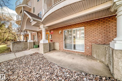Ground-level patio with brick exterior and sliding glass door access - 101 10827 85 Avenue Nw, Edmonton, AB - Outdoor