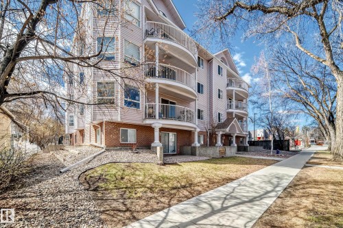 Multi-story residential building featuring light-toned siding and brick veneer - 101 10827 85 Avenue Nw, Edmonton, AB - Outdoor With Facade