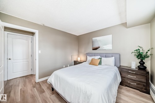 Bedroom featuring light wood-finish flooring, neutral wall paint, and white trim - 101 10827 85 Avenue Nw, Edmonton, AB - Indoor Photo Showing Bedroom