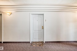 White paneled entry door with brass hardware and peep hole - 
