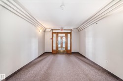 Entryway featuring a wood-framed glass door, complementary side panels, and sconce lighting - 