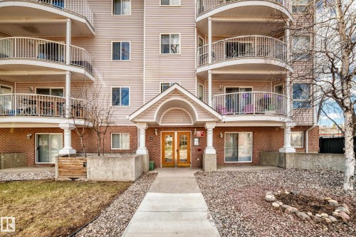 Multi-story building exterior featuring light-toned siding and brick accents - 101 10827 85 Avenue Nw, Edmonton, AB - Outdoor