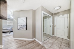 Entryway featuring neutral wall paint, wood-finish flooring, and a tiled landing - 