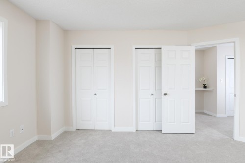 Light gray wall-to-wall carpeting throughout this interior space - 55 14603 Miller Boulevard, Edmonton, AB - Indoor
