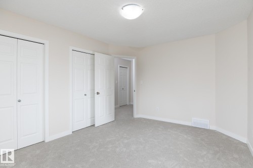 Room featuring light gray carpeting, white baseboards, and neutral wall paint - 55 14603 Miller Boulevard, Edmonton, AB - Indoor Photo Showing Other Room