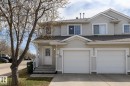 Light-colored siding exterior featuring multiple windows and a gabled roofline - 55 14603 Miller Boulevard, Edmonton, AB  - Outdoor With Facade 