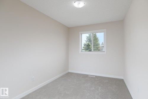 Neutral-toned room featuring a single window, overhead flush mount lighting, light gray carpeting, and white baseboards - 55 14603 Miller Boulevard, Edmonton, AB - Indoor Photo Showing Other Room
