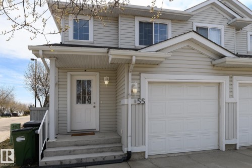 Light-toned siding exterior with a single-car garage and covered entry - 55 14603 Miller Boulevard, Edmonton, AB - Outdoor With Exterior