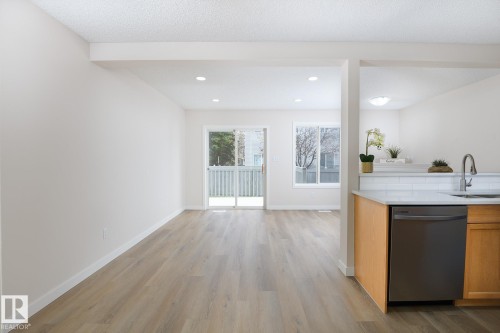 Open concept living space with light wood-finish flooring, white walls, and recessed lighting - 55 14603 Miller Boulevard, Edmonton, AB - Indoor