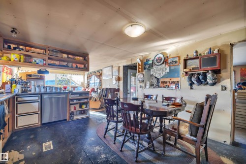 Dining area featuring unfinished concrete flooring - 21 Calmar Mobile Home Park, Calmar, AB - Indoor