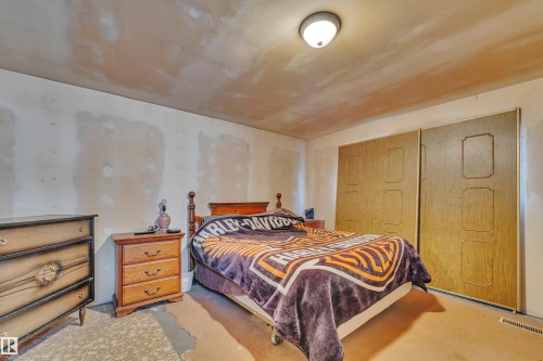 Bedroom featuring a closet and concrete floors - 21 Calmar Mobile Home Park, Calmar, AB - Indoor Photo Showing Bedroom