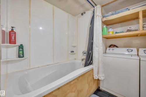 Bathroom with shower / tub combo and washer and clothes dryer - 21 Calmar Mobile Home Park, Calmar, AB - Indoor